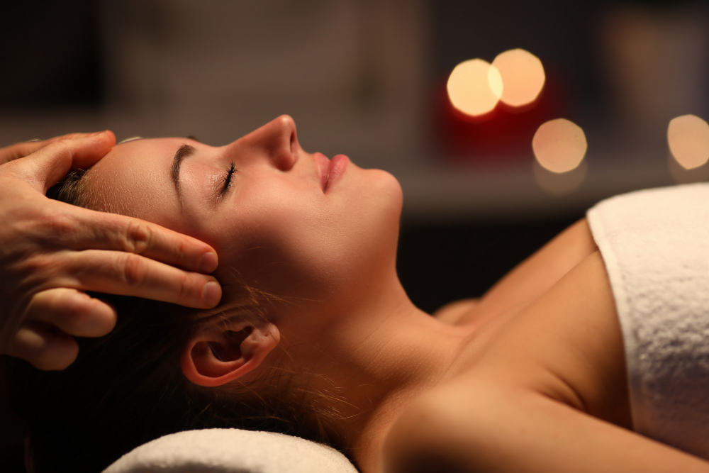 Therapist massaging a client's head and temples