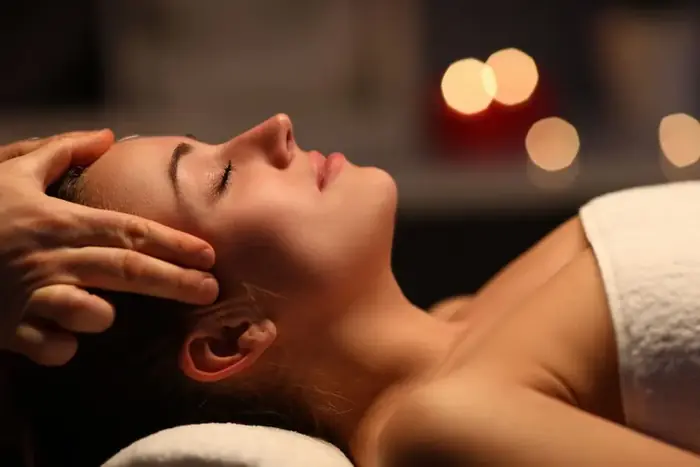 Therapist massaging a client's head and temples