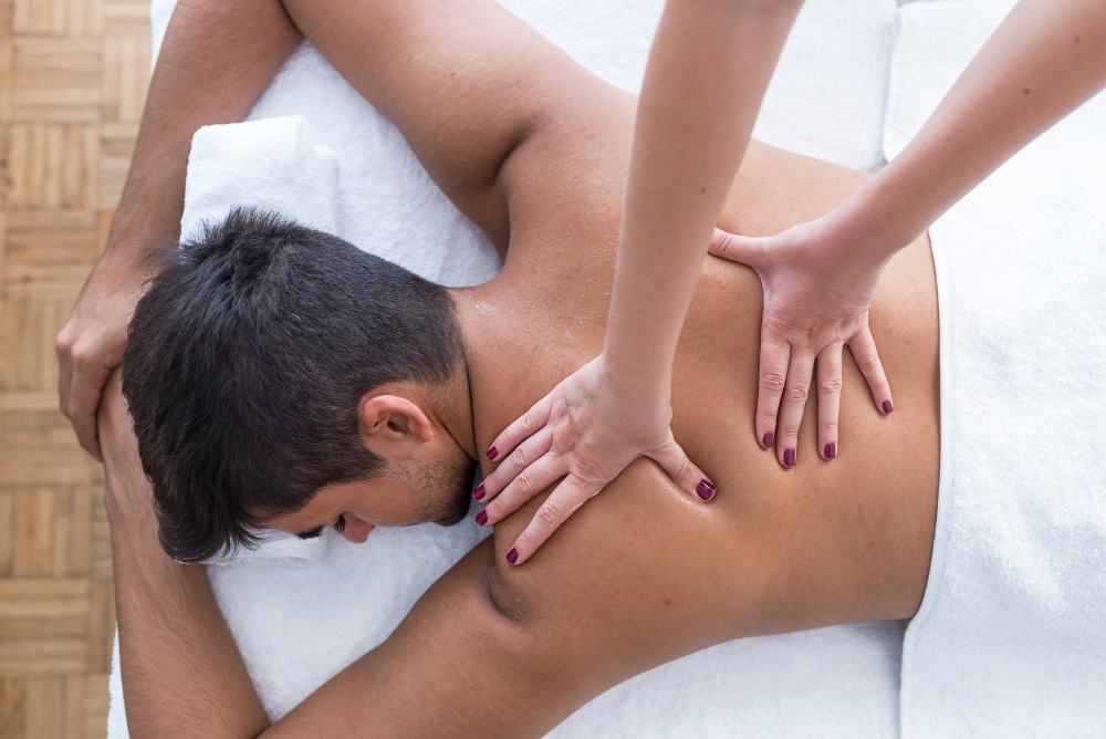 Therapist massaging a client's shoulders and upper back